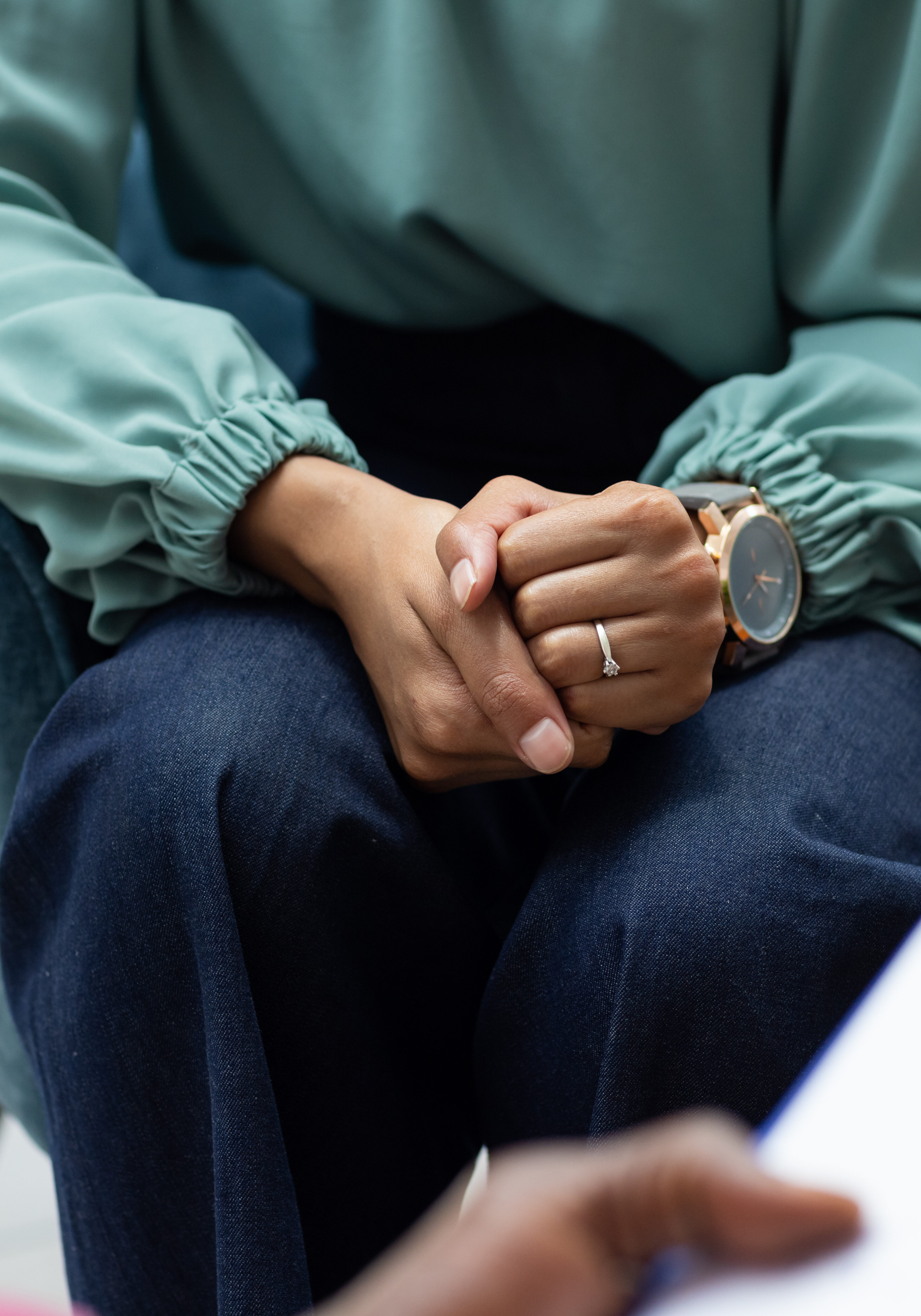 Midsection of biracial female patient attending therapy with african american male therapist. Mental health, therapy and counselling.